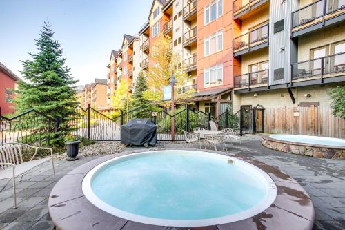 a hot tub in the middle of a courtyard with buildings at Pet-Friendly Silver Mountain Studio Mountain View in Kellogg