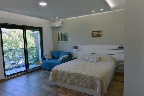 a bedroom with a bed and a blue couch at Hedonica 11 Ema in Vrdnik