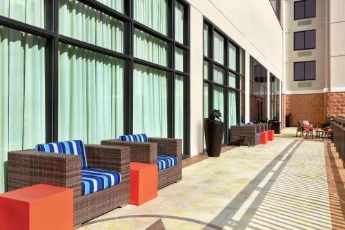a lobby with wicker chairs and large windows at Hampton Inn & Suites Dallas-Mesquite in Mesquite