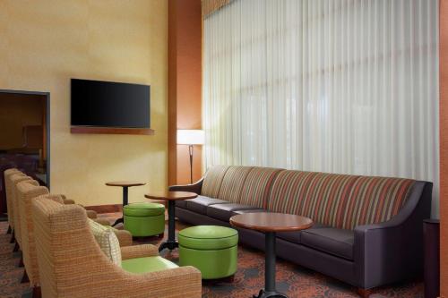 a living room with a couch and chairs and a tv at Hampton Inn & Suites Dallas-Mesquite in Mesquite
