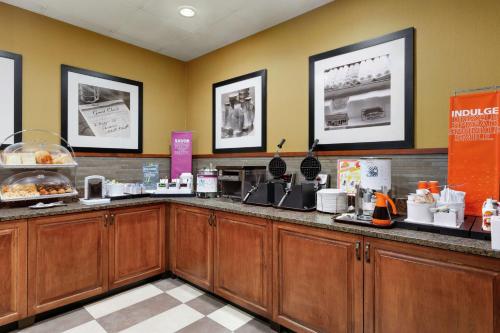 a kitchen with wooden cabinets and a counter at Hampton Inn & Suites Dallas-Mesquite in Mesquite