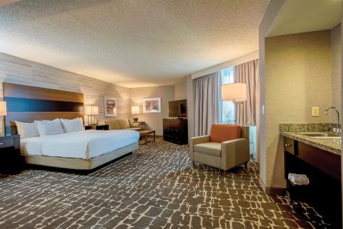 a hotel room with a bed and a bathroom at DoubleTree by Hilton Hotel Denver - Aurora in Aurora