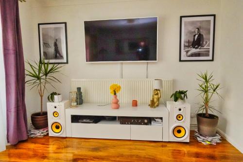 a living room with a white entertainment center at Duchess of Cambridge in Copdock