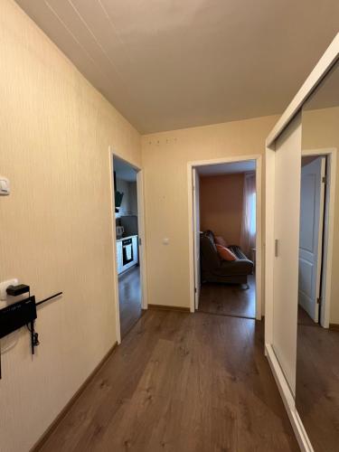an empty living room with a couch in a room at Birch view apartment in Jelgava