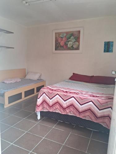 1 dormitorio con 2 camas y una foto en la pared en Loft Praia do Sonho, en Itanhaém
