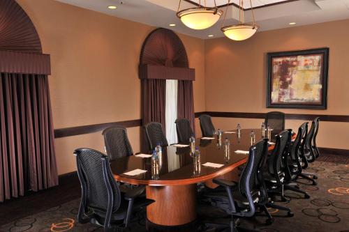 a conference room with a table and chairs at Embassy Suites Des Moines Downtown in Des Moines