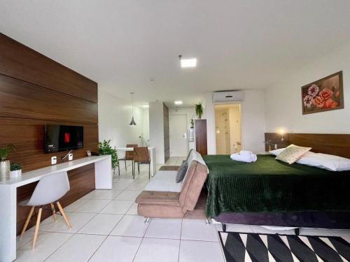 a bedroom with a large bed and a living room at V608 Flat Amplo Aconchegante WI-FI Exclusivo in Brasilia