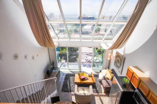 an overhead view of a living room with a large window at Little Italy Modern Lofts in San Diego