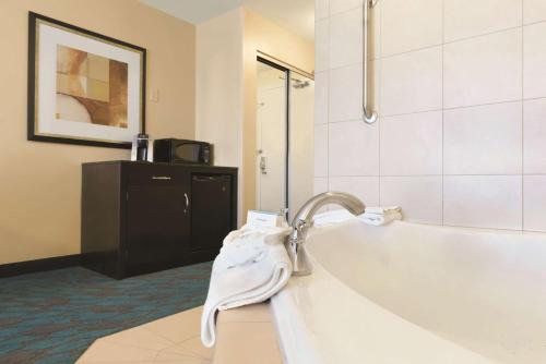 a bathroom with a sink and a bath tub at Hilton Garden Inn Fargo in Fargo