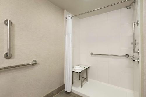a bathroom with a shower and a bath tub at Hilton Fort Collins in Fort Collins