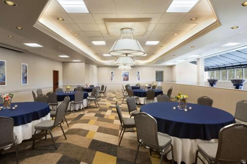a banquet hall with blue tables and chairs at Hilton Fort Collins in Fort Collins