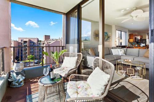a balcony with chairs and a living room with a view at Kahana Manor 619 in Kahana