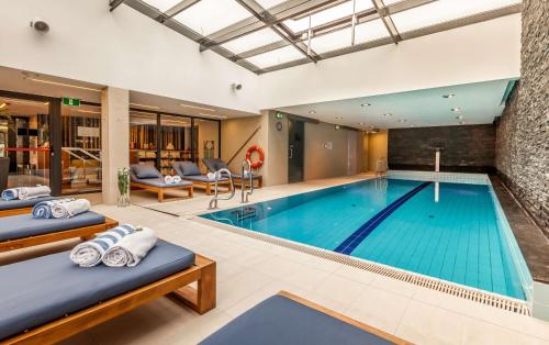 a swimming pool with two beds in a hotel room at Hilton Gdansk in Gdańsk