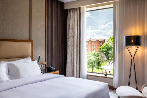 a hotel room with a bed and a window at Hilton Gdansk in Gdańsk