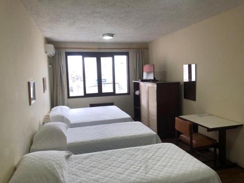 Katil atau katil-katil dalam bilik di Hotel Estoril