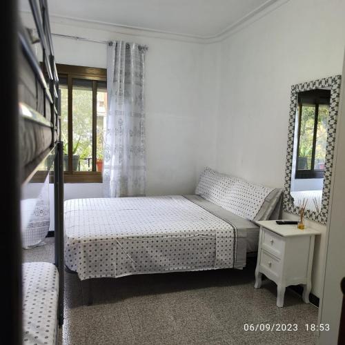 a small bedroom with a bed and a table at Apto Barcelona C R in Santa Coloma de Gramanet