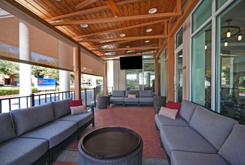 a lobby with couches and a tv on a building at Hilton Garden Inn Houston/Galleria Area in Houston