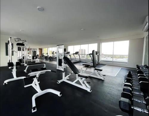 a gym with several treadmills and chairs in it at Departamento de Lujo con Alberca Panoramica en Zona Metropolitana de Guadalajara in Guadalajara