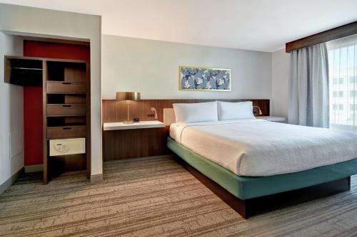 a hotel room with a bed and a window at Hilton Garden Inn Houston/Galleria Area in Houston