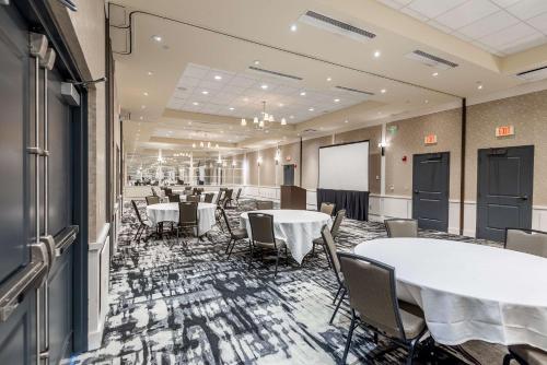 a conference room with tables and chairs and a whiteboard at Hilton Promenade Branson Landing in Branson
