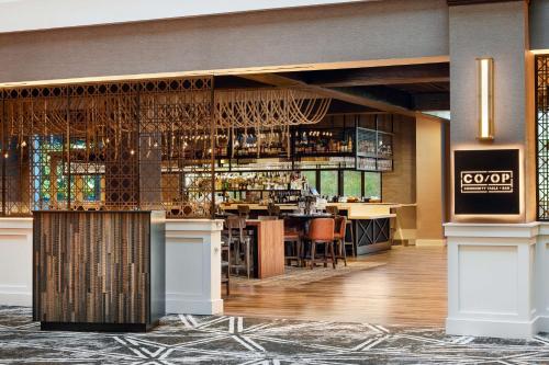 a rendering of a bar in a hotel at Embassy Suites Huntsville in Huntsville