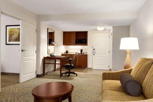 a living room with a couch and a desk at Hilton Garden Inn Shelton in Shelton