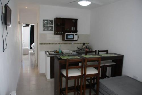 a kitchen with a counter and stools in a room at Hanna Apart in Federación