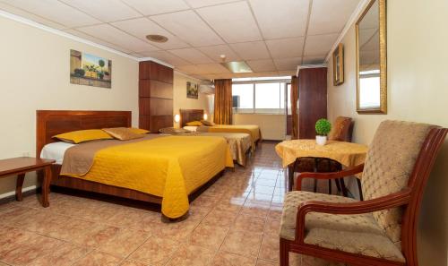 Postel nebo postele na pokoji v ubytování Hotel Malecon Inn