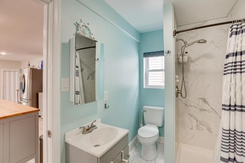 a bathroom with a sink and a toilet and a shower at Wildwood Home with Deck - Walk to Beach and Boardwalk! in Wildwood