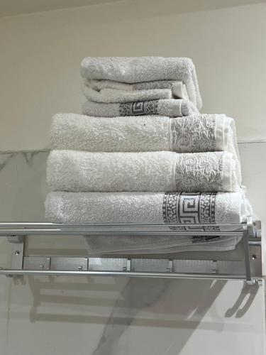a stack of towels on a towel rack at Bel appart+2 ROOM+WIFI+GARE CASA VOYAGEUR+TRAM in Casablanca