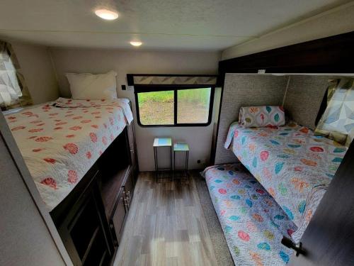 a small room with two beds in a trailer at The Driftwood Oasis in West Palm Beach
