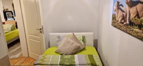 a small room with a bed with a pillow on it at Am alten Siel in Wilhelmshaven
