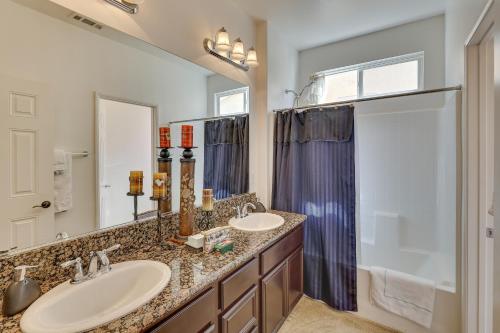 a bathroom with two sinks and a shower at Large Menifee Home 1 Block to Neighborhood Park! in Menifee