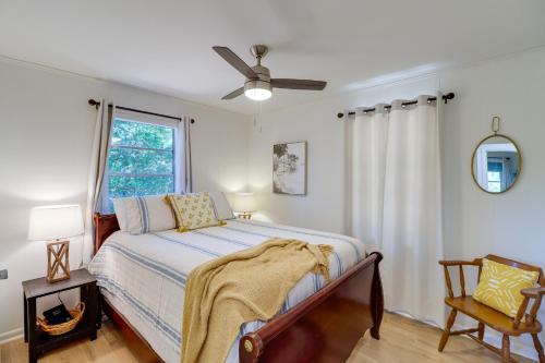 a bedroom with a bed and a ceiling fan at Greers Ferry Hideaway Lake View, Boat Ramp Access in Fairfield Bay
