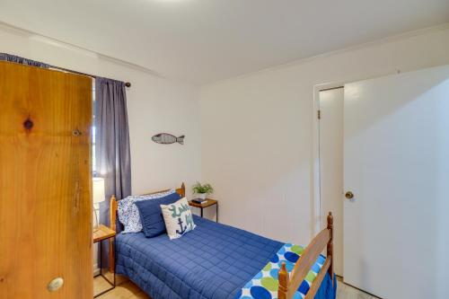 a bedroom with a blue bed and a closet at Greers Ferry Hideaway Lake View, Boat Ramp Access in Fairfield Bay