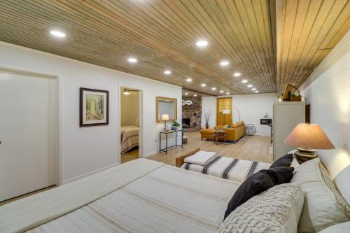 a bedroom with a bed and a living room at Greers Ferry Hideaway Lake View, Boat Ramp Access in Fairfield Bay