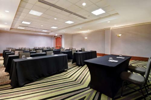 a conference room with tables and chairs in it at Embassy Suites Little Rock in Little Rock