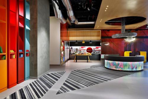 a lobby with colorful walls and a dining room at Aloft Al Mina, Dubai Jumeirah in Dubai