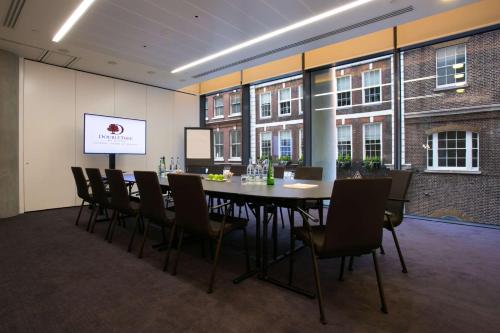 a conference room with a table and chairs at DoubleTree by Hilton Hotel London - Tower of London in London