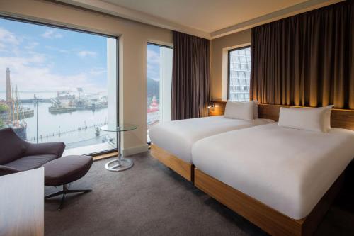 a hotel room with two beds and a large window at Hilton Liverpool City Centre in Liverpool