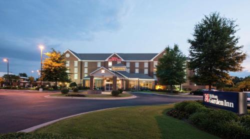 a large building with a sign in front of it at Hilton Garden Inn Macon/Mercer University in Macon