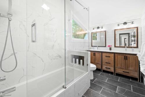 a bathroom with a shower and a toilet and a sink at Commodore Bay Waterfront Home on Lake Norman! in Mooresville