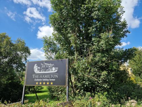 a sign in front of a tree at The Hamilton - The Studio luxury holiday let's in Scorton