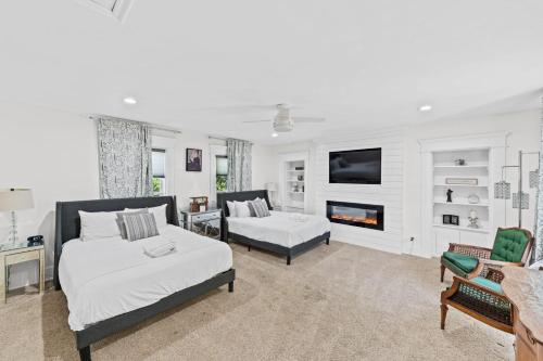 a living room with two beds and a fireplace at Historic Simmons Estate sleeps 20 in Williamstown