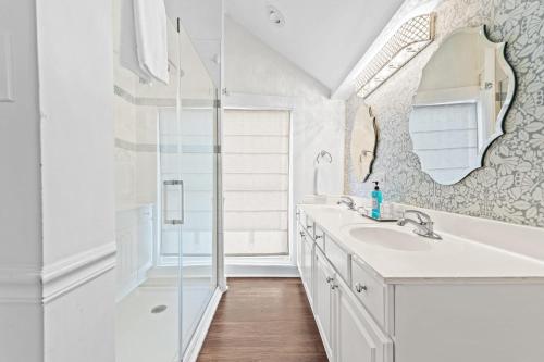 a white bathroom with a sink and a shower at Historic Simmons Estate sleeps 20 in Williamstown