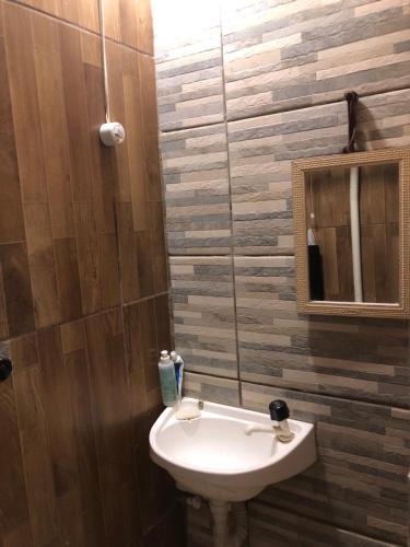 a bathroom with a sink and a mirror at Casinhas Interior Mg in Antônio Prado
