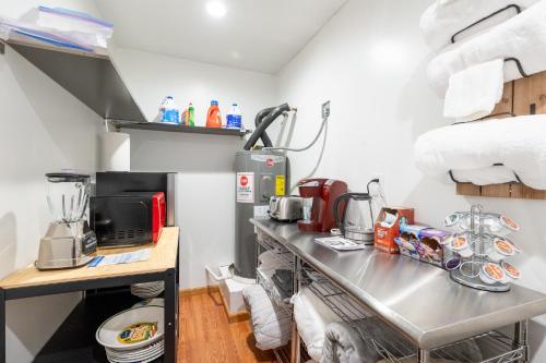 a kitchen with a metal counter with a table at The Marysville Dome - Grannie House in Marysville