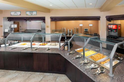 a buffet line in a hotel room with food at Embassy Suites by Hilton Kansas City International Airport in Kansas City