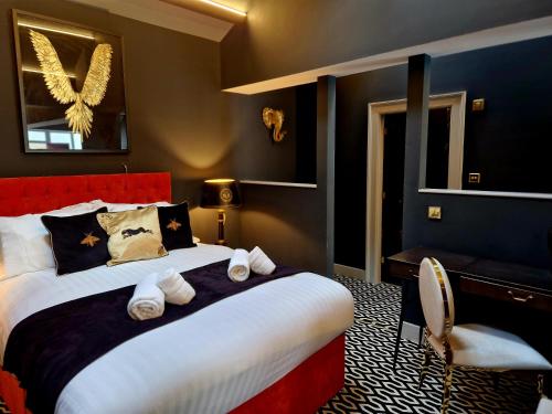 a bedroom with a large bed with towels on it at The Hamilton - The Studio luxury holiday let's in Scorton