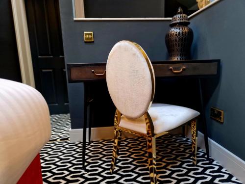 a chair sitting next to a desk in a room at The Hamilton - The Studio luxury holiday let's in Scorton